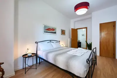 a bedroom with a large bed and a red light at Marco Polo House in Rome