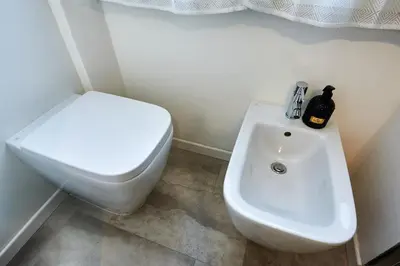 a bathroom with a white toilet and a sink at Marco Polo House in Rome