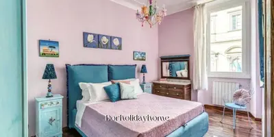 a bedroom with a blue bed and a mirror at dorholidayhome in Rome