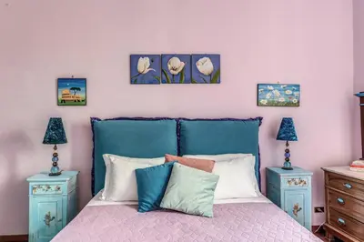 a bedroom with a bed and a blue cabinet at dorholidayhome in Rome