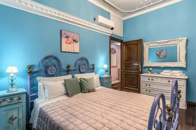 a blue bedroom with a bed and a dresser at dorholidayhome in Rome