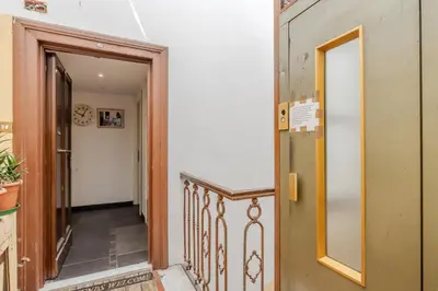 a hallway with an open door and a stairway at TURATI GUEST HOUSe in Rome