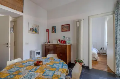 a room with a table and chairs and a bedroom at TURATI GUEST HOUSe in Rome