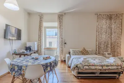 a bedroom with a bed and a table with chairs at TURATI GUEST HOUSe in Rome