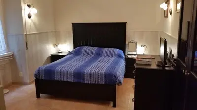 a bedroom with a bed with a blue comforter at Casa Vacanze Nonno Giulio in Rome