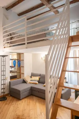 a living room with a couch under a loft bed at Domus Palestro in Rome