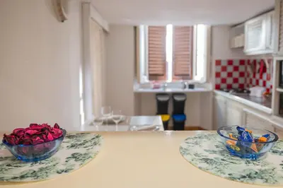 a kitchen with two bowls of roses on a table at Domus Palestro in Rome