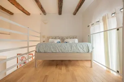 a bedroom with a bed and a large window at Domus Palestro in Rome