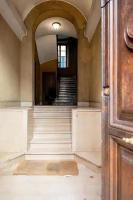 an empty hallway with stairs in a building at Domus Palestro in Rome