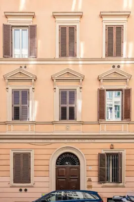 a tall building with windows and a door at Domus Palestro in Rome