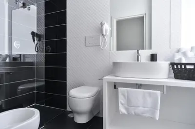 a white bathroom with a sink and a toilet at Lata Luxury Rooms in Rome