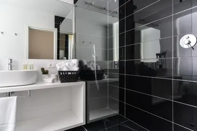 a bathroom with a sink and a mirror at Lata Luxury Rooms in Rome