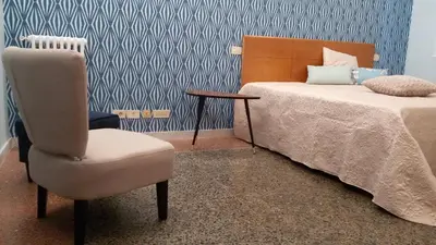 a bedroom with a bed and a chair and a table at Ad Vatican Suites in Rome