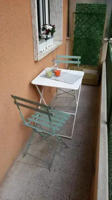 a white table and a chair on a balcony at Ad Vatican Suites in Rome