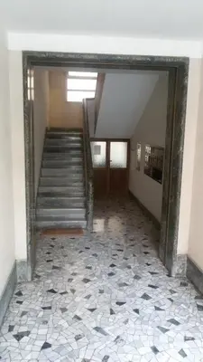 an empty hallway with stairs and a tile floor at Ad Vatican Suites in Rome