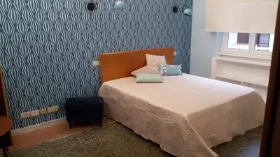 a bedroom with a bed and a blue wall at Ad Vatican Suites in Rome