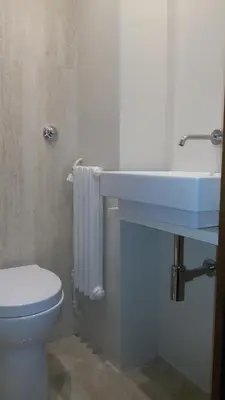 a bathroom with a white toilet and a sink at Ad Vatican Suites in Rome