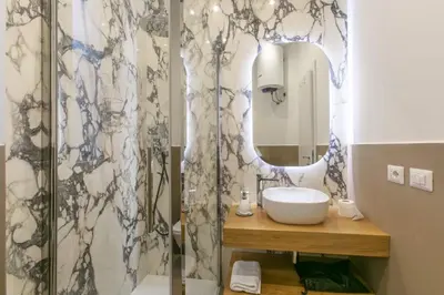 a bathroom with a sink and a mirror at Appia Comfort Zone in Rome