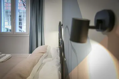 a bedroom with a bed and a lamp next to a window at Appia Comfort Zone in Rome