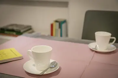 two cups sitting on a pink table with spoons at Appia Comfort Zone in Rome