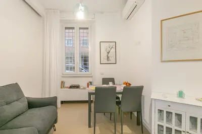 a living room with a table and chairs and a couch at Appia Comfort Zone in Rome