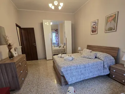 a bedroom with a bed and a dresser and a mirror at Ritiro Romano in Rome