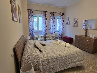 a bedroom with a bed with two towels on it at Ritiro Romano in Rome