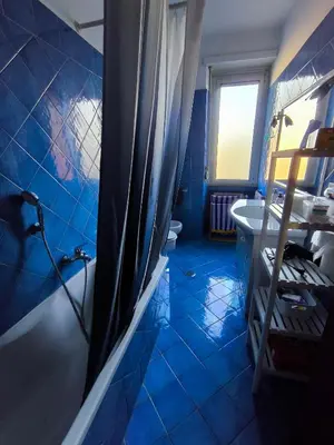 a blue bathroom with a tub and a sink at Basilica santa Maria ausiliatrice in Rome