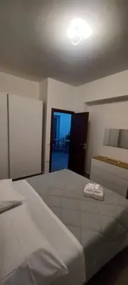 a bedroom with a large bed and a door to a balcony at Alloggio Turistico A casa di Anna in Rome