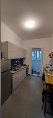 a kitchen with stainless steel appliances and a wooden table at Alloggio Turistico A casa di Anna in Rome