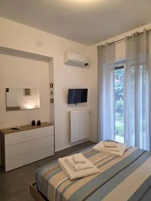 a bedroom with a bed and a desk and a window at Alloggio Turistico A casa di Anna in Rome