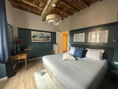 a bedroom with a large bed with blue walls at PianoDue In Trastevere in Rome