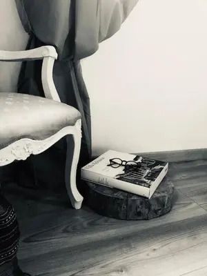 a book sitting on a stool next to a chair at PianoDue In Trastevere in Rome