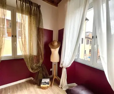 a room with two windows and a lamp in the corner at PianoDue In Trastevere in Rome