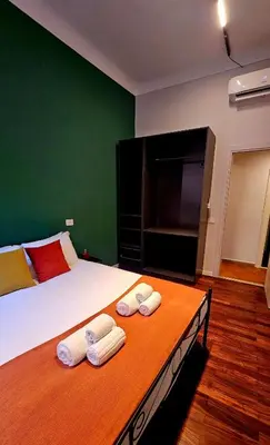a bedroom with a bed with two towels on it at Mica Aurea Apartments Trastevere in Rome