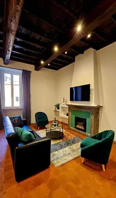 a living room with a couch and a fireplace at Mica Aurea Apartments Trastevere in Rome