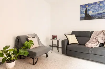 a living room with a couch and a chair at Rome Dolce Vita Luxury Apartment 4 km da Colosseo in Rome