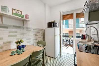 a kitchen with a wooden table and a refrigerator at Rome Dolce Vita Luxury Apartment 4 km da Colosseo in Rome