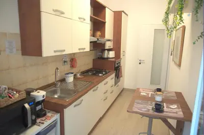 a small kitchen with a sink and a counter at Vatican Malvi Domus in Rome
