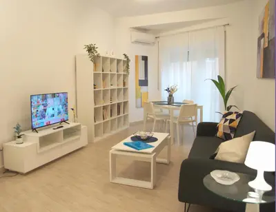 a living room with a couch and a tv and a table at Vatican Malvi Domus in Rome