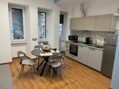 a kitchen with a table and chairs in a kitchen at MNC House Roma in Rome
