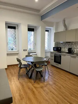 a kitchen and dining room with a table and chairs at MNC House Roma in Rome