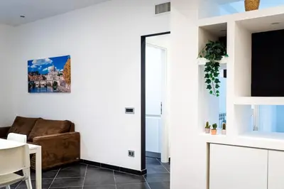 a living room with a couch and a mirror at Sanpietrino Apartment in Rome