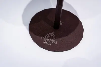 a black hat with a black stick on a table at Sanpietrino Apartment in Rome