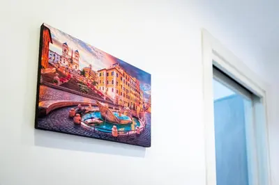 a painting hanging on a wall next to a window at Sanpietrino Apartment in Rome