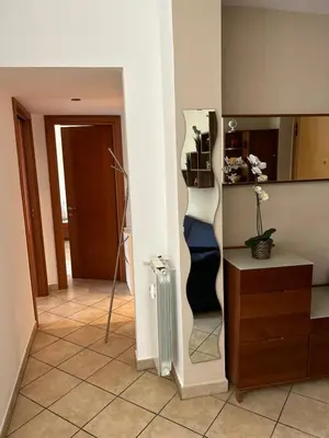 a living room with a shelf and a mirror at Alloggio turistico AVM in Rome