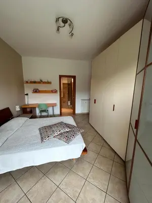 a bedroom with a bed and a desk and a table at Alloggio turistico AVM in Rome