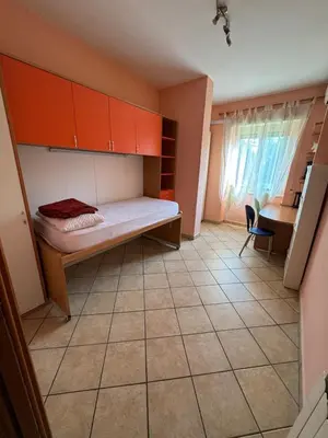 a bedroom with a bed and a desk and a table at Alloggio turistico AVM in Rome
