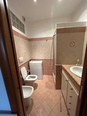 a bathroom with a toilet and a sink at Alloggio turistico AVM in Rome