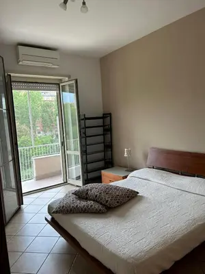 a bedroom with a bed and a sliding glass door at Alloggio turistico AVM in Rome